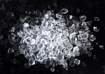 Crushed ice on black background. Top view with copy space