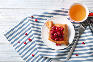 Plate with puff and cherry on striped napkin