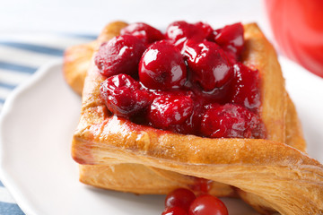 Plate with puff and cherry, closeup