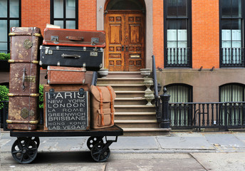 Luggage tourists with big suitcases on a cart