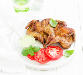 Roasted partridges of tobacco with salsa and tomato sauce.