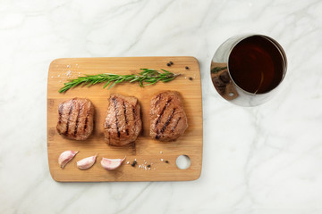 Three slices of cooked meat with seasoning and wine
