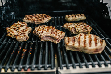 Grilled beef steak on the grill, close-up.