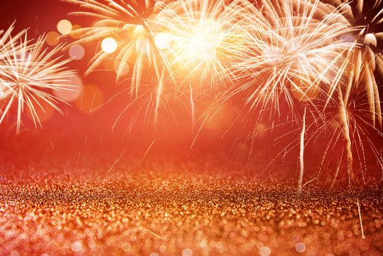 Holiday Red and Gold Fireworks and bokeh in New Year eve and copy space. Abstract background celebration.