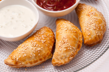 Empanadas with red and white sauce