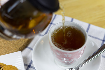 Man Pouring tea in house

