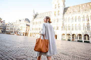 Young female tourist walking on the main square with city hall in the old town of Brussels in...