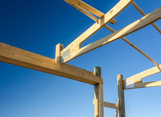 Garage truss pole building. Timber, wooden truss attachment. Construction site framing