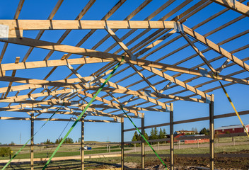 Garage construction in suburbia, USA. Closeup. Roof view. Wood, wooden roof truss system. Suburban building.