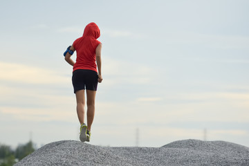 Woman running. Female runner jogging, training for marathon. Fit girl fitness athlete model exercising outdoor