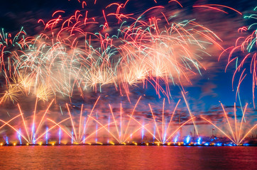 Salutes and fireworks over the river neva in the white night.