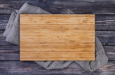 Serving tray over old wooden table, cutting board on dark wood background, top view - Powered by Adobe