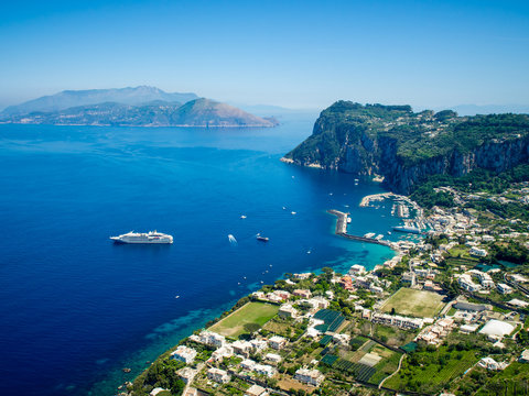 aerial view of italian holiday island Capri with picturesque marina and Tyrrhenian sea in background, Capri island, Campania region, Italy