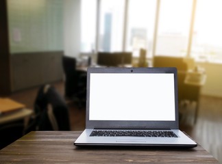 Laptop computer with white blank screen on wooden table with blurred office background with sunlight effect, working business in office, online social media technology, searching data concept