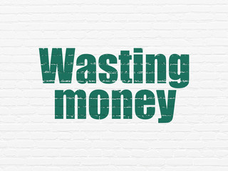 Banking concept: Wasting Money on wall background