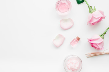 homemade spa with rose cosmetic set, cream, salt and oil on white background top view mock-up