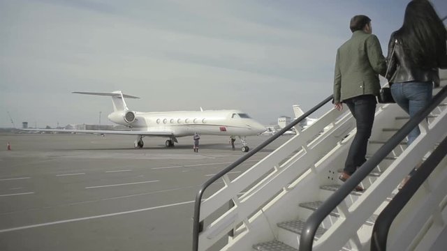 The passengers are boarding at the airplane