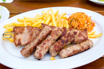 Cevapcici and sis kebab, turkish style barbecued meat with french fries