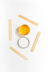 Wax and sticks for depilation on white background top view copyspace