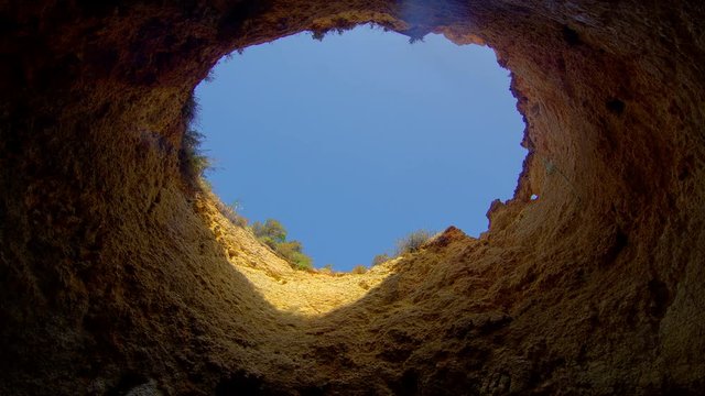 Time lapse with moving shadows and light from the hole cave, Algarve, Portugal 