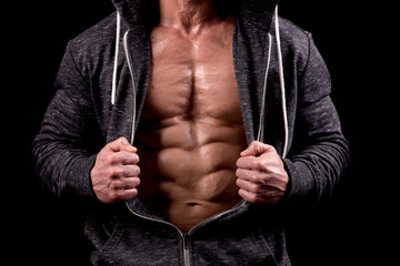 Fototapeta na wymiar fit muscular man posing isolated on a dark background