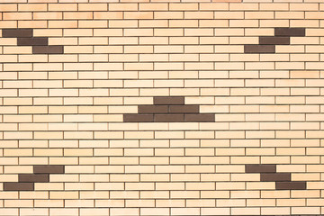 Texture of a wall of yellow brick with a pattern