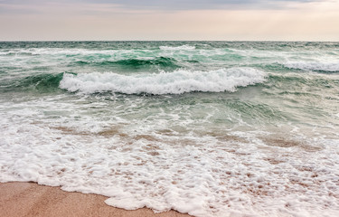 sea ​​waves running on sandy beach