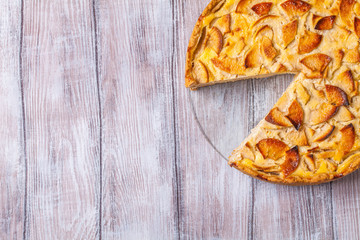 Apple pie, red apples on a gray background, horizontally, copyspace