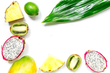Set of exotic fruits. Dragonfruit, pineapple, mango, lime and kiwi on white background top view copyspace
