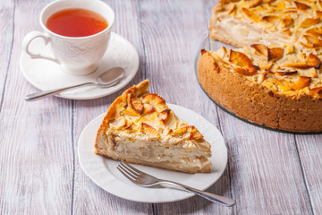 Apple pie, red apples on a gray background, horizontally