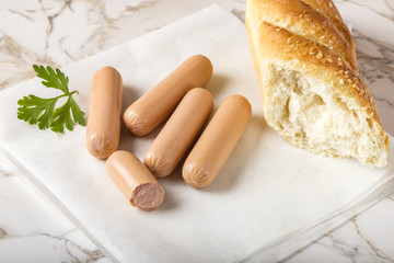 Sausages (Frankfurter) on table with bread