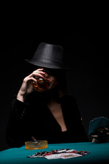 Studio shot of beautiful young woman playing poker.