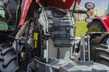 Powerful high-tech tractor engine in modern design, mounted on a frame with an open hood - 162287412