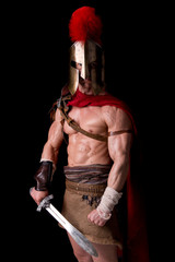 gladiator posing isolated in dark