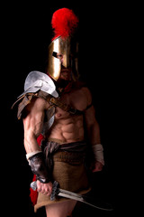 gladiator posing isolated in dark