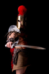 gladiator posing isolated in dark