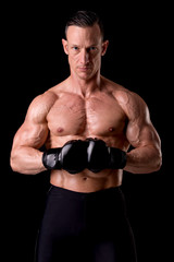 Naklejka premium fighter posing with gloves isolated on a dark background