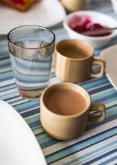 Tibetan milk tea with a glass of water in hotel at Lachen. North Sikkim, India.