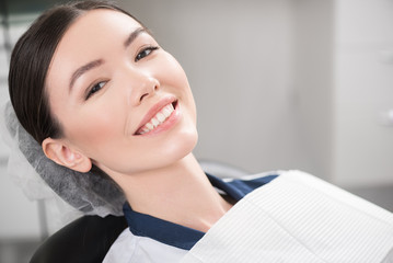 Outgoing patient smiling in dental office