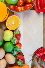 Healthy concept with mixed fruits and vegetables on wooden background