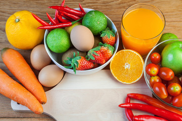 Healthy concept with mixed fruits and vegetables on wooden background