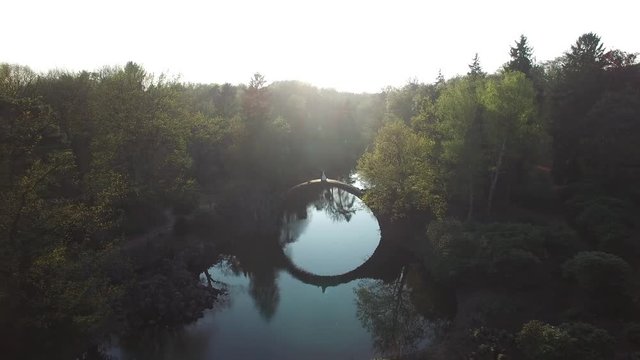 Rainbow over Devil's bridge in the park Kromlau, Germany, top view