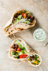 Healthy snack, lunch. Traditional Greek wrapped sandwich gyros - tortillas, bread pita with a...
