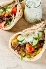 Healthy snack, lunch. Traditional Greek wrapped sandwich gyros - tortillas, bread pita with a...
