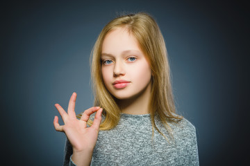 Closeup Portrait of handsome teen show Ok isolate on grey background