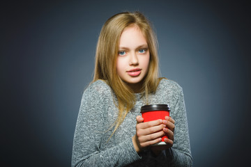 teenage girl drink red cup of coffee isolated on gray background