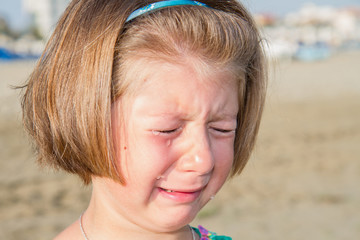 Little girl crying at the beach