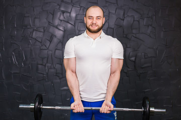 Fototapeta na wymiar sport, bodybuilding, lifestyle and people concept - smiling man with barbell