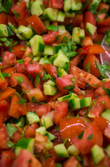 Buffet restaurant. Fresh red wet tomatoes lie on the plates.