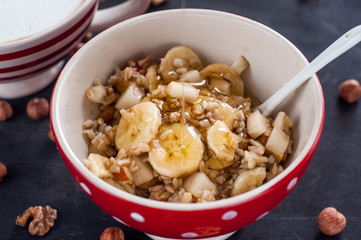 Healthy breakfast, oatmeal, banana, pear, honey, flax seeds, chia seeds